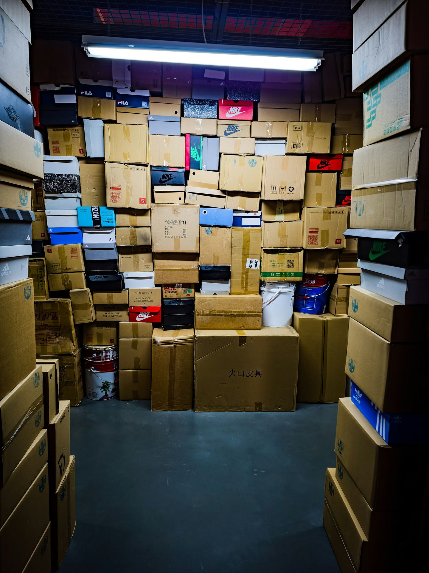 A room filled with many stacked cardboard boxes.